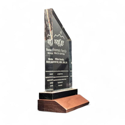 Clear acrylic corporate award with wood block stand.