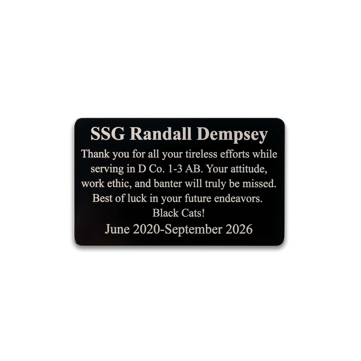 A black rectangular memorial plaque with rounded corners and white text reading 'SSG Randall Dempsey' followed by a memorial message and dates, shown on a plain white background.