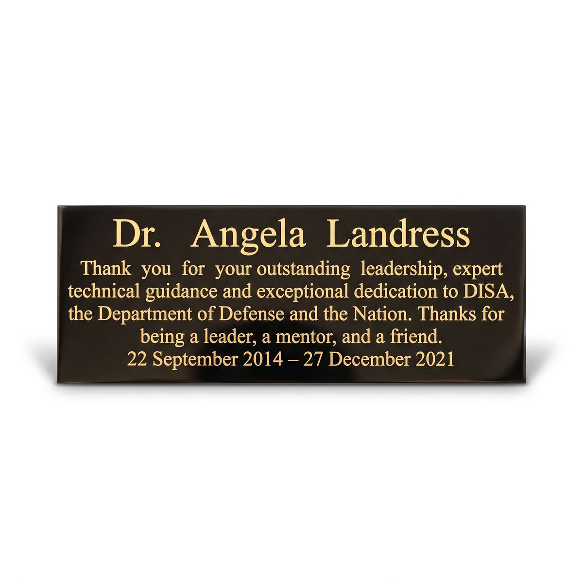 A rectangular black memorial plaque with gold lettering, shown on a clean white background with a soft shadow. The plaque is personalized with the name 'Dr. Angela Landress in recognition for her leadership and dedication to DISA, the Department of Defense and the Nation.