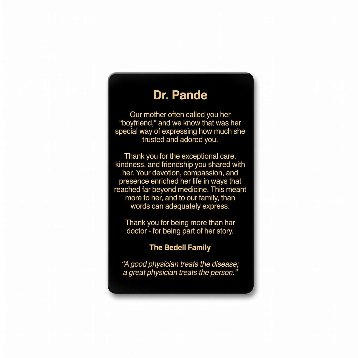 A black rectangular memorial plaque with rounded corners, featuring a printed personalized tribute to Dr. Pande in white and gold text, shown against a plain white background.