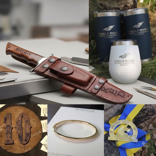 A collage showing branded Eagle River products: a brown leather knife sheath with a knife, two dark insulated tumblers, a white insulated tumbler, a wooden engraved plaque, a gold ring, and a blue/yellow engraved ribbon award, alongside a large dark wood background panel.