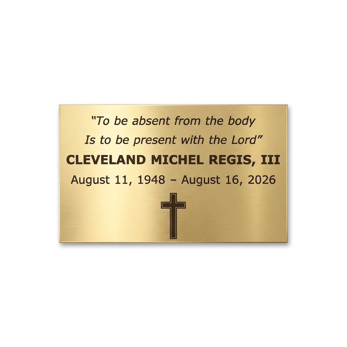 A rectangular brushed gold memorial plaque with black engraved text and a black cross, shown on a plain white background.