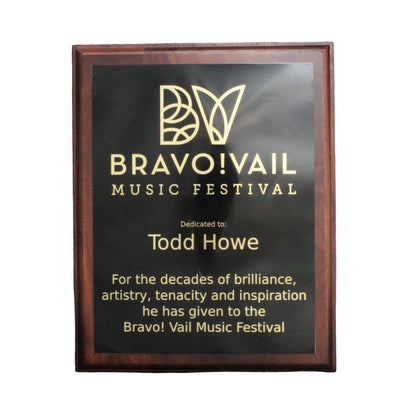 Dark stained wood plaque with black plate engraved for Bravo Vail in Colorado.